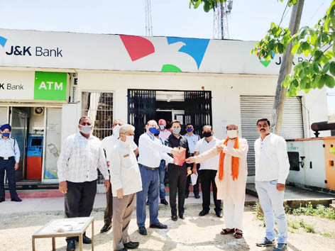 Sanitizers being distributed among J&K Bank employees.