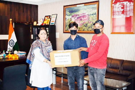 Sarpanch Sanjeet Singh handing over a boxful of medicines to DC Reasi Indu Kanwal Chib.