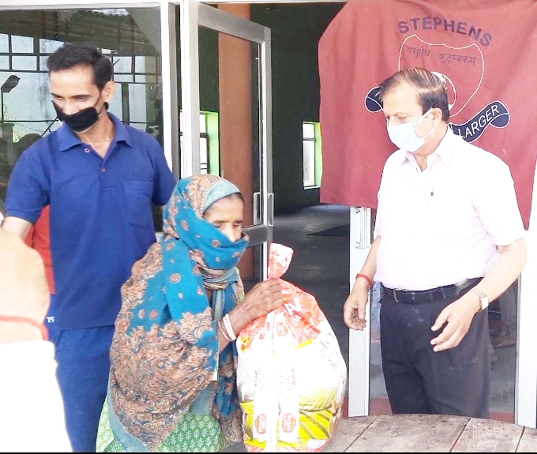 Management of Stephens College of Nursing and SIPS distributing ration among needy persons.