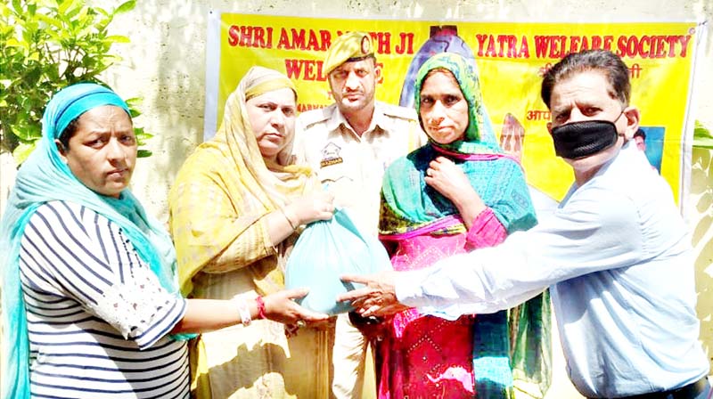 Shri Amarnathji Yatra Welfare Society J&K distributing ration among needy people.