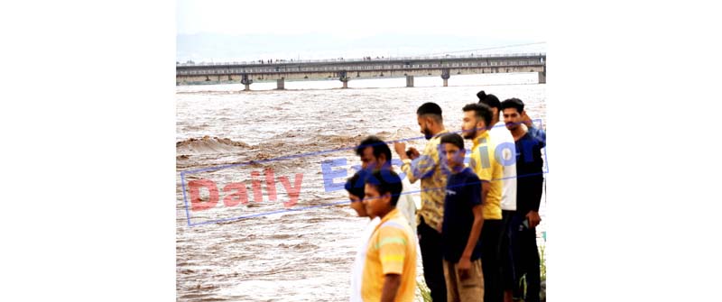 Flooded Tawi river flows near alert mark in Jammu on Thursday.-Excelsior/Rakesh