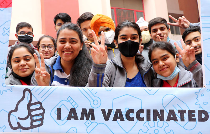 Students of a school flashing victory sign after getting first dose of COVID-19 vaccine in Jammu on Monday. (UNI)