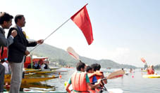 Minister for Tourism and Culture Rigzan Jora flagging off water sports festival at Manasbal on Thursday.