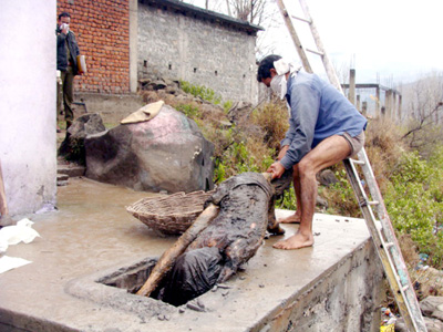 Murdered man's body being dragged out of a gutter at Mendhar on Saturday.
