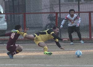 Footballer losing balance during a match of Christmas Soccer Championship in Jammu on Wednesday. - Excelsior/Rakesh Footballer losing balance during a match of Christmas Soccer Championship in Jammu on Wednesday. - Excelsior/Rakesh