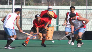 Players battling to get hold of the ball during a semifinal match of the Shaheed Bhagat Singh Memorial Hockey Tournament at Jammu on Friday. -Excelsior/ Rakesh Players battling to get hold of the ball during a semifinal match of the Shaheed Bhagat Singh Memorial Hockey Tournament at Jammu on Friday. -Excelsior/ Rakesh