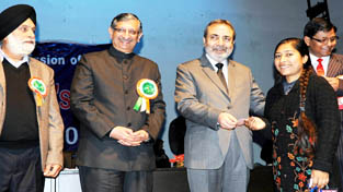 Chief Secretary Mohd Iqbal Khandey and others giving a EPIC card to a beneficiary at Jammu on Saturday. Chief Secretary Mohd Iqbal Khandey and others giving a EPIC card to a beneficiary at Jammu on Saturday.