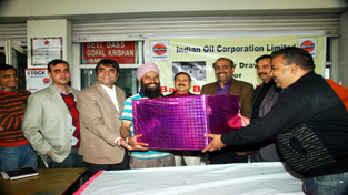 A lucky winner being given prize at IOCL outlet at Narwal on Friday.