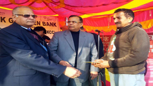 Chairman, JKGB, Vagish Chander giving away loan cheque to a beneficiary during a camp at Chowki Choura in Akhnoor.