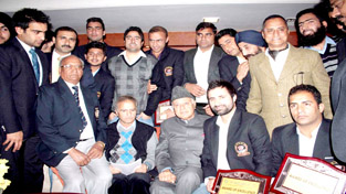 President JKCA Dr Farooq Abdullah and J&K Ranji Trophy skipper Parvez Rasool and other members posing for a group photograph during a felicitation function. -Excelsior/Rakesh President JKCA Dr Farooq Abdullah and J&K Ranji Trophy skipper Parvez Rasool and other members posing for a group photograph during a felicitation function. -Excelsior/Rakesh