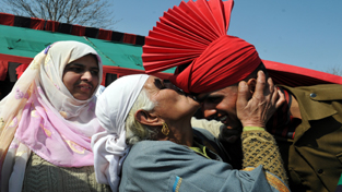 A soldier of Jammu and Kashmir Light Infantry is kissed by his proud grand mother after taking part in a passing out parade for admission to the Indian Army at a military base on the outskirts of Srinagar, at Regimental Centre on Saturday. — Excelsior/Amin War A soldier of Jammu and Kashmir Light Infantry is kissed by his proud grand mother after taking part in a passing out parade for admission to the Indian Army at a military base on the outskirts of Srinagar, at Regimental Centre on Saturday. — Excelsior/Amin War