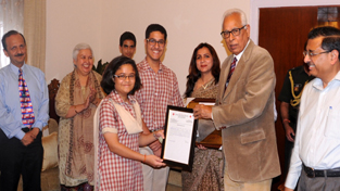 Governor N N Vohra felicitating students at Raj Bhawan.
