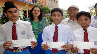Uddit Khullar, Navjot Singh and Raja Babu, students of Naveen Shiksha Kendra, Bari Brahmana, who won medals in 59th National School Games Jump Rope Championship held at Chhattisgarh. They were awarded with the cash prizes of Rs 10000, Rs 5000 and Rs 1750 respectively by Directorate of Youth Services and Sports, J&K. B S Slathia, Managing Director of the School handed over the cheques to the students in the function held in their honour. Also seen in the picture are Principal Rajeev Slathia and Vice Principal, Pratibha Jamwal.