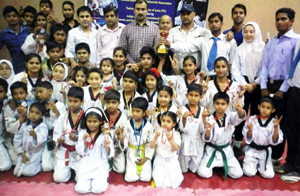 Young Taekwondo players posing for a group photograph alongwith the chief guest Ranjeet Kalra, Member BCCI and other dignitaries in Jammu. Young Taekwondo players posing for a group photograph alongwith the chief guest Ranjeet Kalra, Member BCCI and other dignitaries in Jammu.