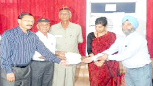 Principal, Government College for Women (GCW), Udhampur, Dr Youdhvir Singh along with District Development Commissioner (DDC) Udhampur Yasha Mudgal presenting a draft of Rs 36,500 to Colonel Juneza, Founder member and Chairperson of Poorva Sainik Sewa Parishad, Udhampur for the construction of Shahidi Sathal for the martyrs of district Udhampur.