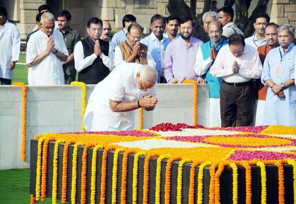 Prime Minister designate Narendra Modi paying tribute to Father of the Nation Mahatma Gandhi at Rajghat before his oath as Prime Minister of India in New Delhi on Monday. (UNI ) Prime Minister designate Narendra Modi paying tribute to Father of the Nation Mahatma Gandhi at Rajghat before his oath as Prime Minister of India in New Delhi on Monday. (UNI )
