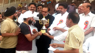 Winners receiving trophy from Prof Saif-ud-Din Soz and Raman Bhalla at MA Stadium, Jammu on Sunday.