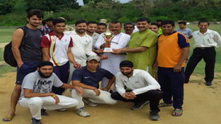 Winners of Major Pritam Singh T-20 Cricket Tournament receiving title trophy from Jugal Kishore Sharma at Badhori ground, Jammu on Sunday.