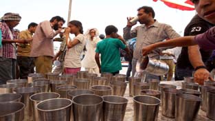 People being served Sharbat on the occasion of Nirjala Ikadashi on Monday. -Excelsior/ Rakesh