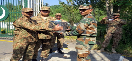 India and Pakistan Army officials exchange sweets at Chakan-Da-Bagh in Poonch on Monday. —Excelsior/Harbhajan