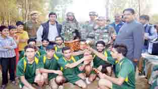 Jubilant team of Manigam XI posing for a group photograph alongwith the dignitaries after defeating Chanderkot in the volleyball final organised by a Rashtriya Rifles at Kulgam in Valley. Jubilant team of Manigam XI posing for a group photograph alongwith the dignitaries after defeating Chanderkot in the volleyball final organised by a Rashtriya Rifles at Kulgam in Valley.