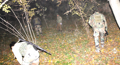 Cops conducting searches after attack on police bus in Awantipora on Tuesday. -Excelsior/Younis Khaliq