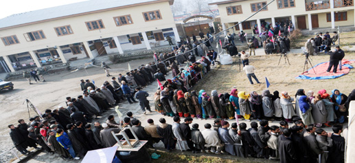 People stand in a long queue as they wait to cast their vote at a polling station in Handwara on Tuesday. -Excelsior/Amin War