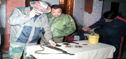 An officer looks at the weapon seized from militant in Poonch on Thursday.—Excelsior/Harbhajan