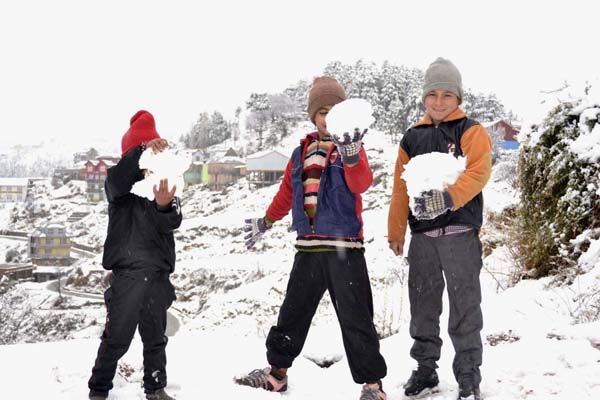 Children playing with snow-balls at Basantgarh in Udhampur on Wednesday. -Excelsior/Vasu Gupta