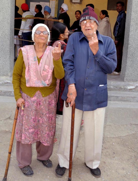An elderly couple voters showing mark of indelible ink after casting their votes, at a polling booth, during the Delhi Assembly election in Delhi on Saturday.(UNI) An elderly couple voters showing mark of indelible ink after casting their votes, at a polling booth, during the Delhi Assembly election in Delhi on Saturday.(UNI)