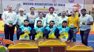 Wushu gold medallist Bhanu Pratap and other players posing along with chef-de-mission, HS Gill and other dignitaries at Thriruvananthapuram in Kerala on Friday. Wushu gold medallist Bhanu Pratap and other players posing along with chef-de-mission, HS Gill and other dignitaries at Thriruvananthapuram in Kerala on Friday.