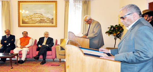 Governor N N Vohra administering oath to Mohammad Shafi Uri as Pro-tem Speaker in Raj Bhawan on Friday.