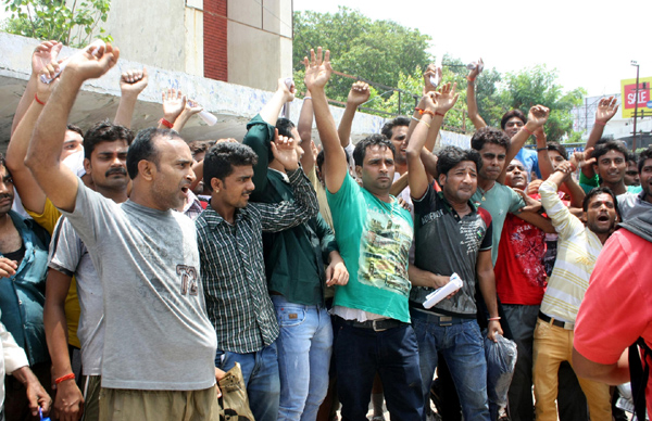 Yatris protesting in front of Jammu Haat on Wednesday. —Excelsior/Rakesh