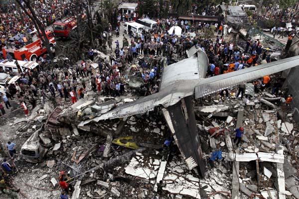 Security forces and rescue teams examine the wreckage of an Indonesian military C-130 Hercules transport plane after it crashed into a residential area in the North Sumatra city of Medan, Indonesia on Tuesday. (UNI) Security forces and rescue teams examine the wreckage of an Indonesian military C-130 Hercules transport plane after it crashed into a residential area in the North Sumatra city of Medan, Indonesia on Tuesday. (UNI)