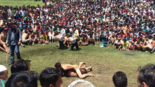 Wrestlers displaying skill in a hard fought bout in presence of large crowd during a wrestling competition at Doda. Wrestlers displaying skill in a hard fought bout in presence of large crowd during a wrestling competition at Doda.