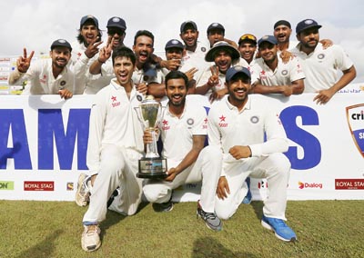 -Indian cricket team members posing for photographs with the trophy after winning final test cricket match and the series against Sri Lanka in Colombo on Tuesday.(UNI) -Indian cricket team members posing for photographs with the trophy after winning final test cricket match and the series against Sri Lanka in Colombo on Tuesday.(UNI)