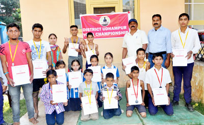 Medal winners of District Udhampur Yoga Championship displaying certificates while posing for a group photograph. Medal winners of District Udhampur Yoga Championship displaying certificates while posing for a group photograph.