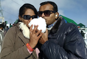 A tourist couple poses for a photograph with snowball after heavy snowfall in upper reaches of world-famous ski resort of Gulmarg, on Monday. — Excelsior/Amin War A tourist couple poses for a photograph with snowball after heavy snowfall in upper reaches of world-famous ski resort of Gulmarg, on Monday. — Excelsior/Amin War