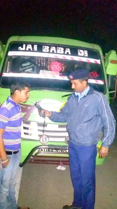 Traffic cop analyzing a driver with breath analyzer. Traffic cop analyzing a driver with breath analyzer.