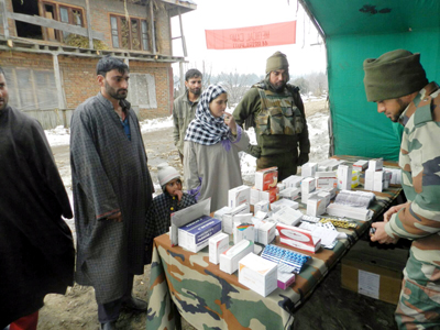 An Army doctor and local people during a medical camp at Kathohalan in Shopian district. An Army doctor and local people during a medical camp at Kathohalan in Shopian district.