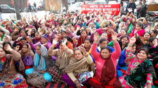 Anganwadi workers and helpers staging protest in Jammu on Tuesday. -Excelsior/ Rakesh Anganwadi workers and helpers staging protest in Jammu on Tuesday. -Excelsior/ Rakesh