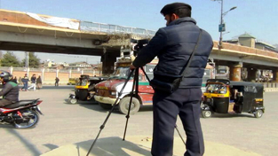 A cop keeping an eye on traffic violators. A cop keeping an eye on traffic violators.