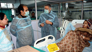 Deputy Commissioner Srinagar enquiring about health of a patient in a hospital. Deputy Commissioner Srinagar enquiring about health of a patient in a hospital.