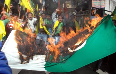 Activists of Dogra Front burning Pakistan Flag during a protest at Jammu. -Excelsior/ Rakesh Activists of Dogra Front burning Pakistan Flag during a protest at Jammu. -Excelsior/ Rakesh