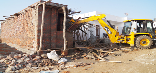 An illegal structure on forest land being demolished in Sunjwan area on Monday. -Excelsior/ Rakesh