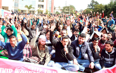 State Govt employees and temporary workers staging protest dharna outside Divisional Commissioner’s Office in Jammu on Monday. -Excelsior/Rakesh State Govt employees and temporary workers staging protest dharna outside Divisional Commissioner’s Office in Jammu on Monday. -Excelsior/Rakesh