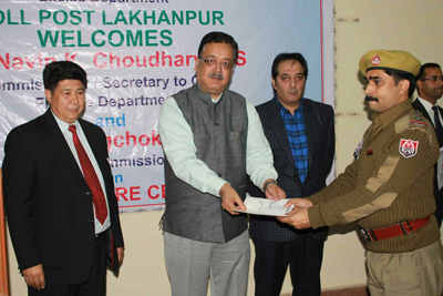 Commissioner Secretary Finance Navin Choudhary giving away award to an official of Excise Department. Commissioner Secretary Finance Navin Choudhary giving away award to an official of Excise Department.