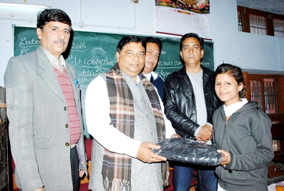 BJP State President, Sat Sharma distributing uniforms among students at GHSS Rehari on Saturday. BJP State President, Sat Sharma distributing uniforms among students at GHSS Rehari on Saturday.
