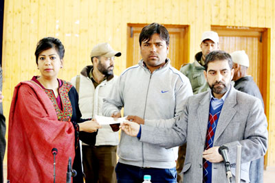 Deputy Commissioner Baramula, Yasha Mudgal, distributing relief cheques among flood victims. -Excelsior/Aabid Nabi Deputy Commissioner Baramula, Yasha Mudgal, distributing relief cheques among flood victims. -Excelsior/Aabid Nabi