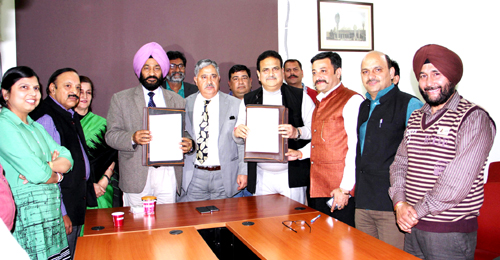 PCJ president and CUJ Registrar displaying copies of MoU in presence of VC and others on Wednesday. PCJ president and CUJ Registrar displaying copies of MoU in presence of VC and others on Wednesday.